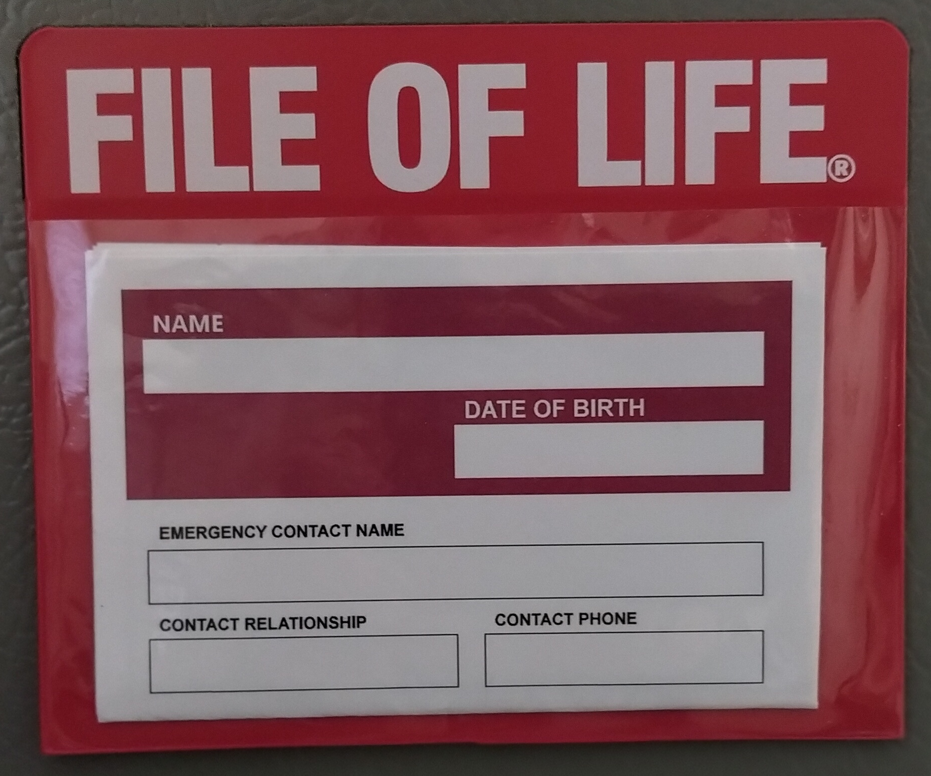 [photo of red plastic pouch with magnetic strip on back]